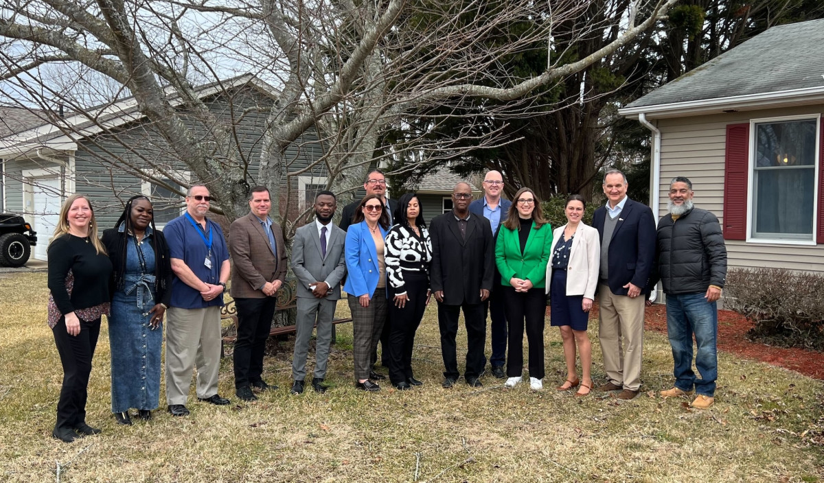 McBride stands with honorees and staff at a recognition ceremony hosted by CHIMES Delaware.