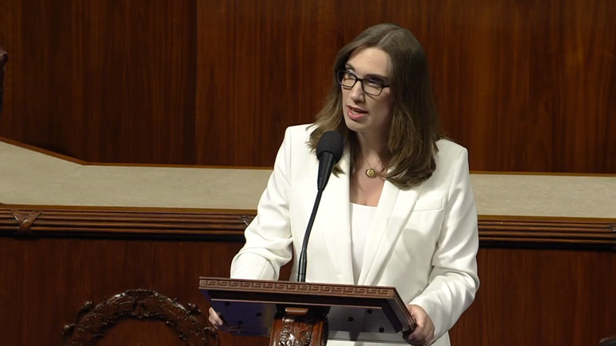 Rep. McBride speaks into a microphone at a podium on the House floor.