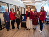 Senator Coons, Blunt Rochester, and Rep. McBride stand with leaders at Goodwill Opportunity Hub in Wilmington
